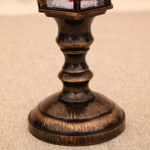Close-up of vintage bronze base with brushed metallic texture for Christmas snow globe lamp