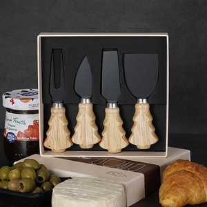Close-up of 4-piece cheese knife set with Christmas tree handles in a gift box