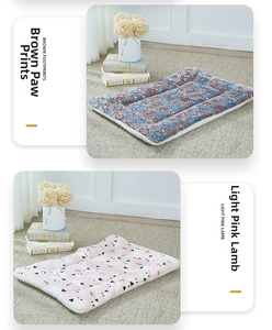 Detail of plush pet mats showing brown paw and pink lamb patterns in soft fleece fabric