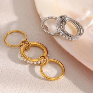 Three-layer 18K gold plated stainless steel stacking rings with white pearls on a shell