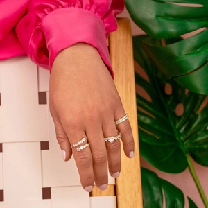 Detailed view of layered gold-plated rings featuring heart-cut zircon and pavé setting