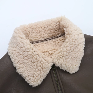 Detail of brown PU leather jacket featuring a warm white shearling collar and metal zipper