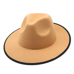 Side view of camel wool fedora with black ribbon edge detailing on a flat brim