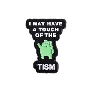 Funny green frog enamel pin with I MAY HAVE A TOUCH OF THE 'TISM text on black metal base