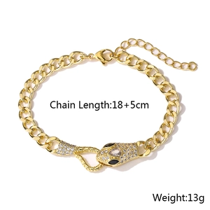 Detail of 18K gold-plated snake head clasp set with white zircons and black gemstone eyes