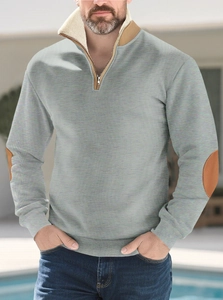Detail of grey half-zip sweatshirt featuring beige inner collar and brown elbow patches