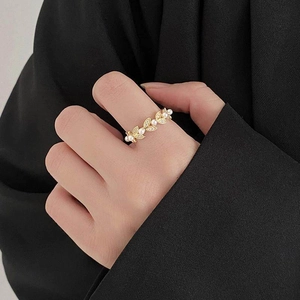 Elegant gold leaf ring with white pearls and zircons worn on finger for a vintage look