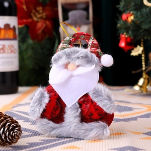 Detail of Santa plush ornament with red knit hat and faux fur beard on festive background