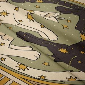 Close-up of soft flannel tapestry showing detailed cat and celestial star print texture