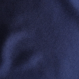 Macro shot of navy blue satin dress fabric featuring fine twill texture and soft sheen