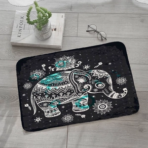 Detail of square flannel absorbent mat with mandala elephant print on wooden floor
