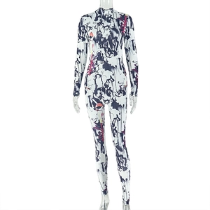 Detail of high-neck long-sleeve jumpsuit featuring abstract blue and red art prints
