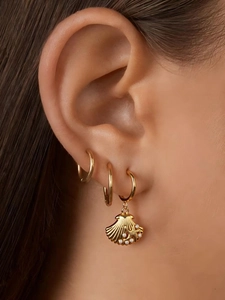 Detailed view of 18k gold plated stainless steel hoop earrings with shell and starfish charms