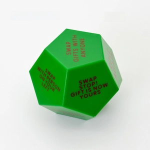 Close-up of green 12-sided Christmas gift exchange dice with red game instructions