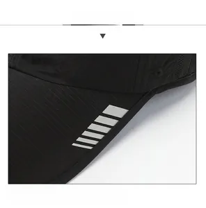 Close-up of breathable mesh fabric and reflective stripes on a black quick-dry baseball cap