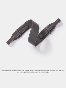 Detail of 4cm wide grey litchi grain leather shoulder strap with silver clasps