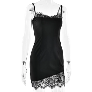 Close-up of black satin dress featuring delicate lace trim on the irregular hemline