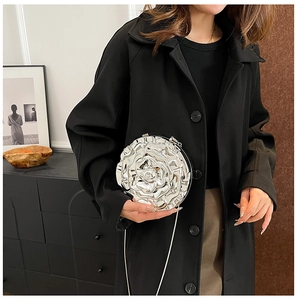 Detail shot of a silver 3D rose-shaped jelly clutch bag with a delicate metal chain strap
