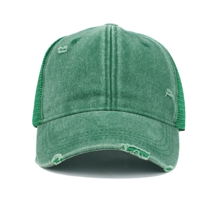 Detail of dark green washed cotton baseball cap with breathable mesh and distressed holes