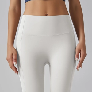 Detail of high waisted white yoga pants with convenient side pockets and supportive fabric