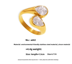 Macro detail of gold-plated stainless steel ring with dual pear-cut zircon stones