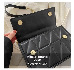 Detail of black quilted shoulder bag featuring gold magnetic buckles and triangle texture