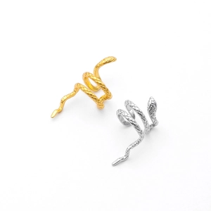 Detailed macro view of textured gold and silver snake ear cuffs with lifelike scales