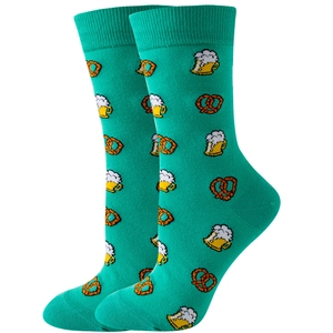 Detailed knit texture of green mid-calf socks with beer mug and pretzel patterns