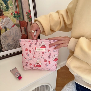 Macro detail of pink quilted cotton makeup bag featuring cute rabbit floral prints
