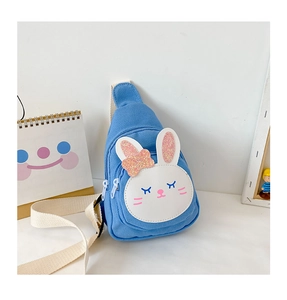 Detail of blue canvas rabbit chest bag featuring sequin bow and adjustable strap