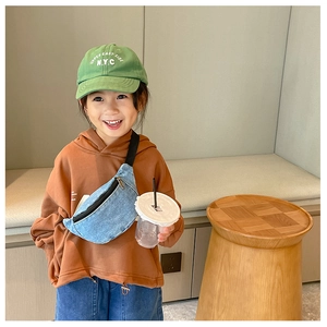 Kids denim crossbody chest bag in blue worn by a child in a casual daily setting