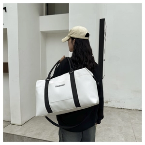 White Oxford cloth travel bag with black straps and brand logo on a person's shoulder