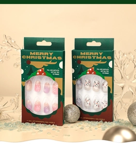 Detail view of Christmas press-on nail sets with snowflake and snowman patterns in festive boxes