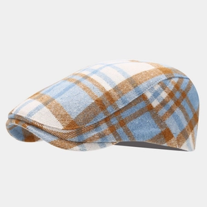 Détail de la casquette plate à carreaux bleus et marrons avec texture tissée fine