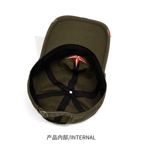 Detail view of cotton baseball cap interior featuring red star embroidery and metal buckle