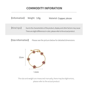 Macro shot of 18k gold plated flower bracelet with red zircons and measurement details