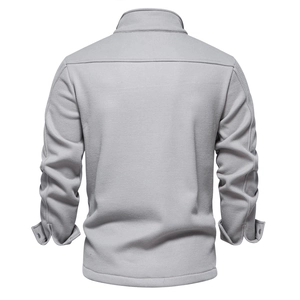 Macro detail of men's grey waffle knit texture and back shoulder seam on thick jacket