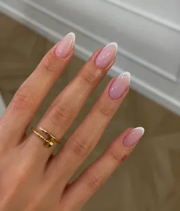 Classic almond-shaped French tip press-on nails with white edges and natural pink base
