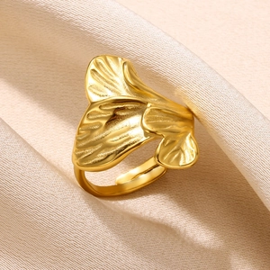 Close-up of golden ginkgo leaf ring showing detailed bionic leaf textures on silk