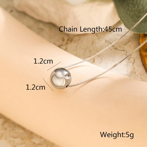 Detail shot of a polished spherical pendant necklace with 45cm chain length and 5g weight