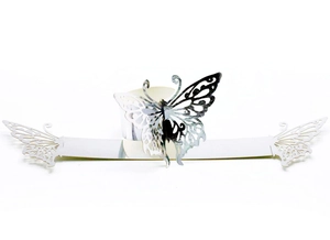 Macro detail of silver mirror finish laser-cut butterfly paper napkin ring decoration