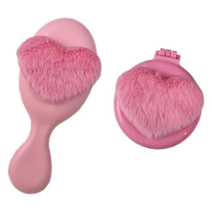 Pink heart plush air cushion comb and folding mirror set for travel on white background