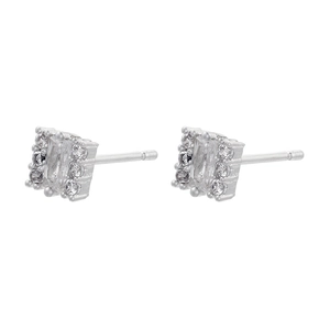 Macro view of geometric silver earrings with baguette cut zircon and pavé crystals