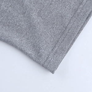 Detail of grey knitted fabric showing professional double stitching and soft texture