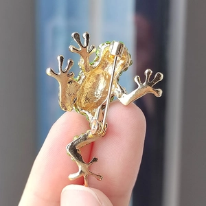 Detail view of the secure pin clasp and gold alloy backing of the green frog brooch