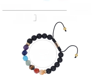 Macro detail of 10mm tiger eye chakra beads with adjustable braided cord for yoga