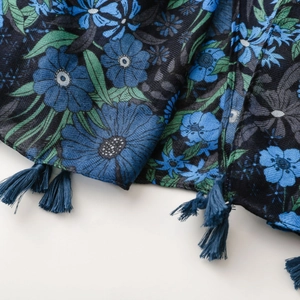 Detailed close-up of vintage dark blue floral scarf with elegant hanging tassels