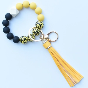 Close-up of leopard print silicone beads wristlet with yellow PU tassel and gold hook