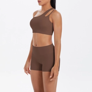 Detail of chocolate brown one-shoulder sports bra and high-waist yoga shorts set