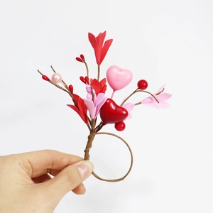 Detail of red and pink floral heart napkin ring with berries and brown wire base